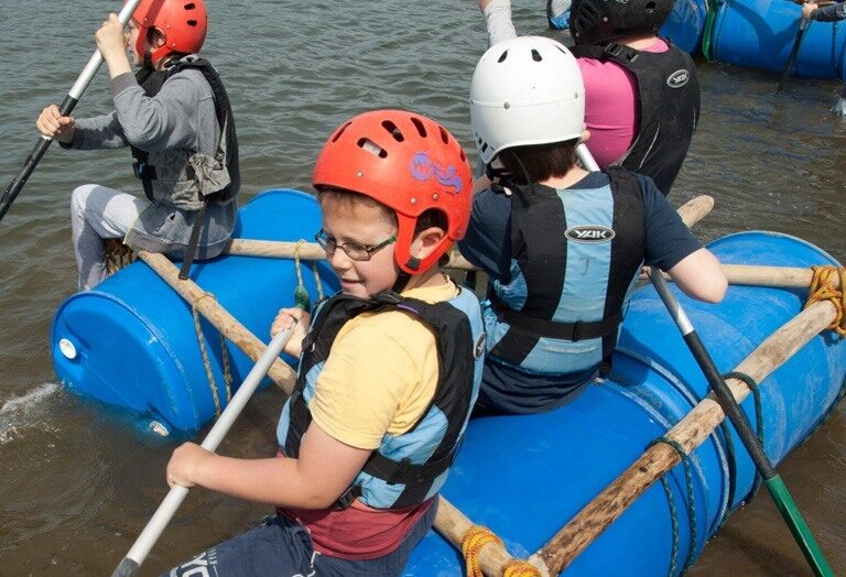 Kids setting sail on their raft