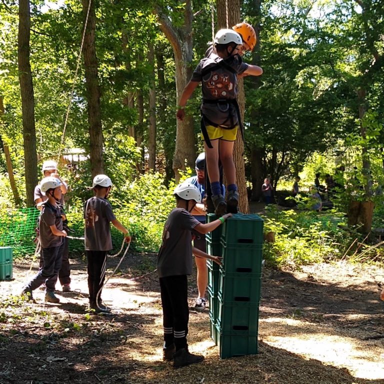 group of children participating in crate stacking challenge