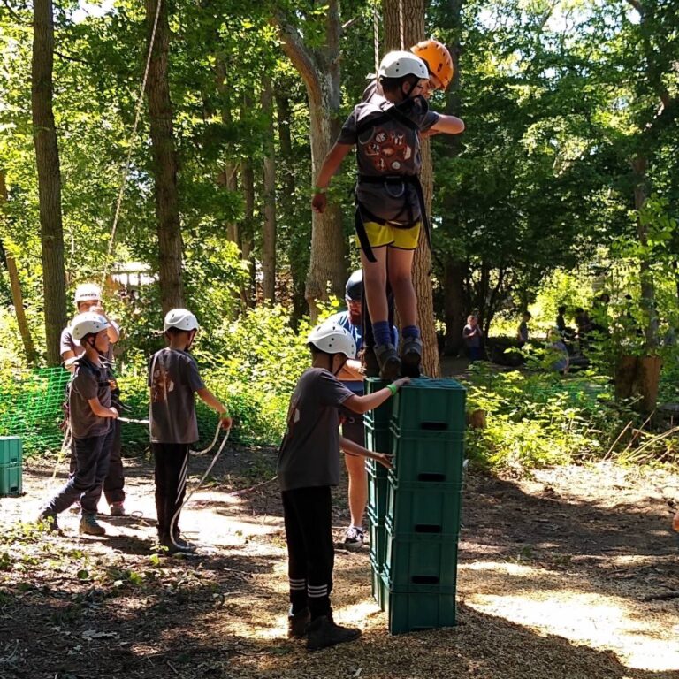 65433872_2559929267386742_4645750134196404224_o group of children participating in crate stacking challenge